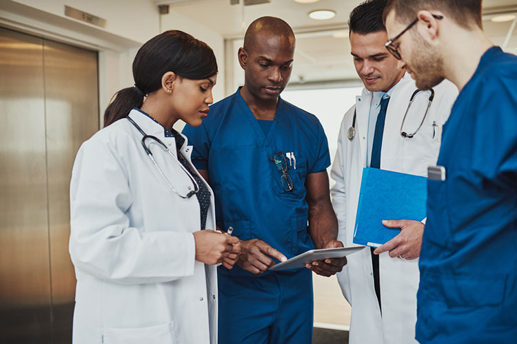A nurse educator talks with students