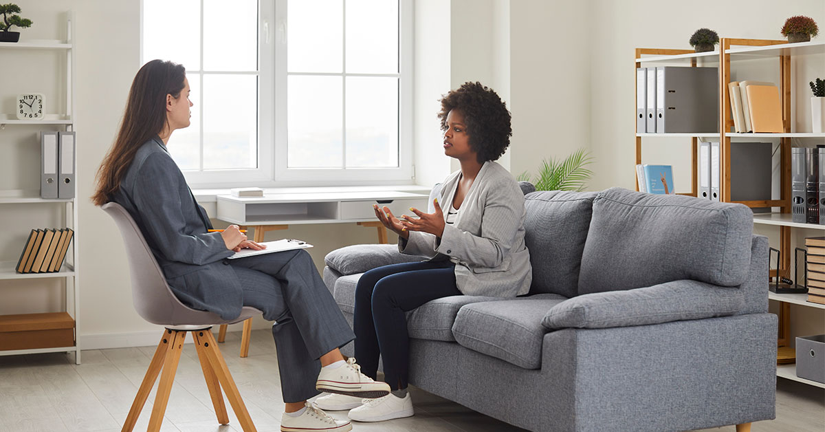 Mental health counselor sitting and talking to a client