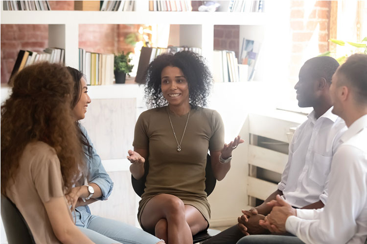 psychologist counselling speaking with diverse people sitting in circle