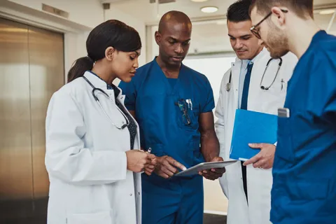 A nurse educator talks with students